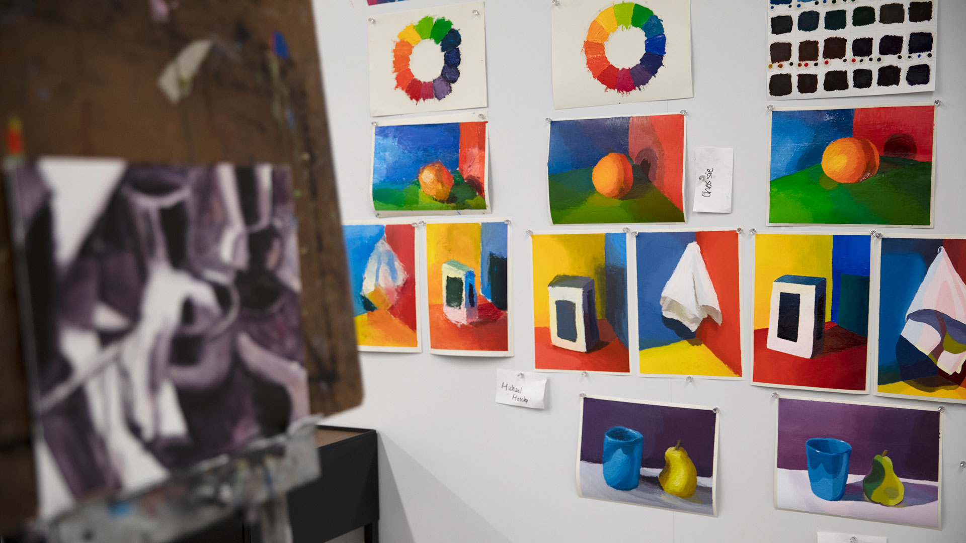 Student color theory artwork hanging on a board