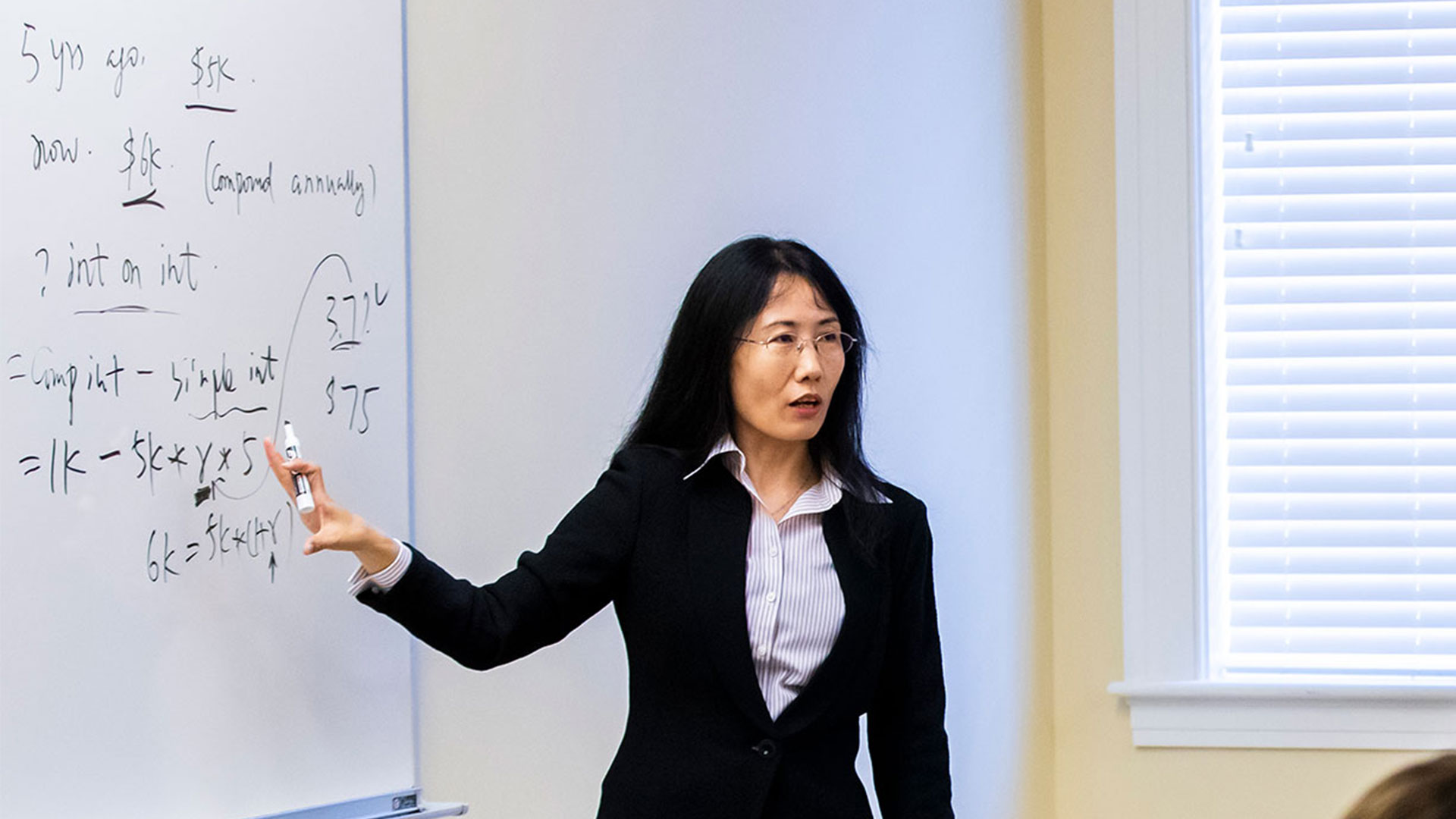 Professor Susan Ji teaching a business class.
