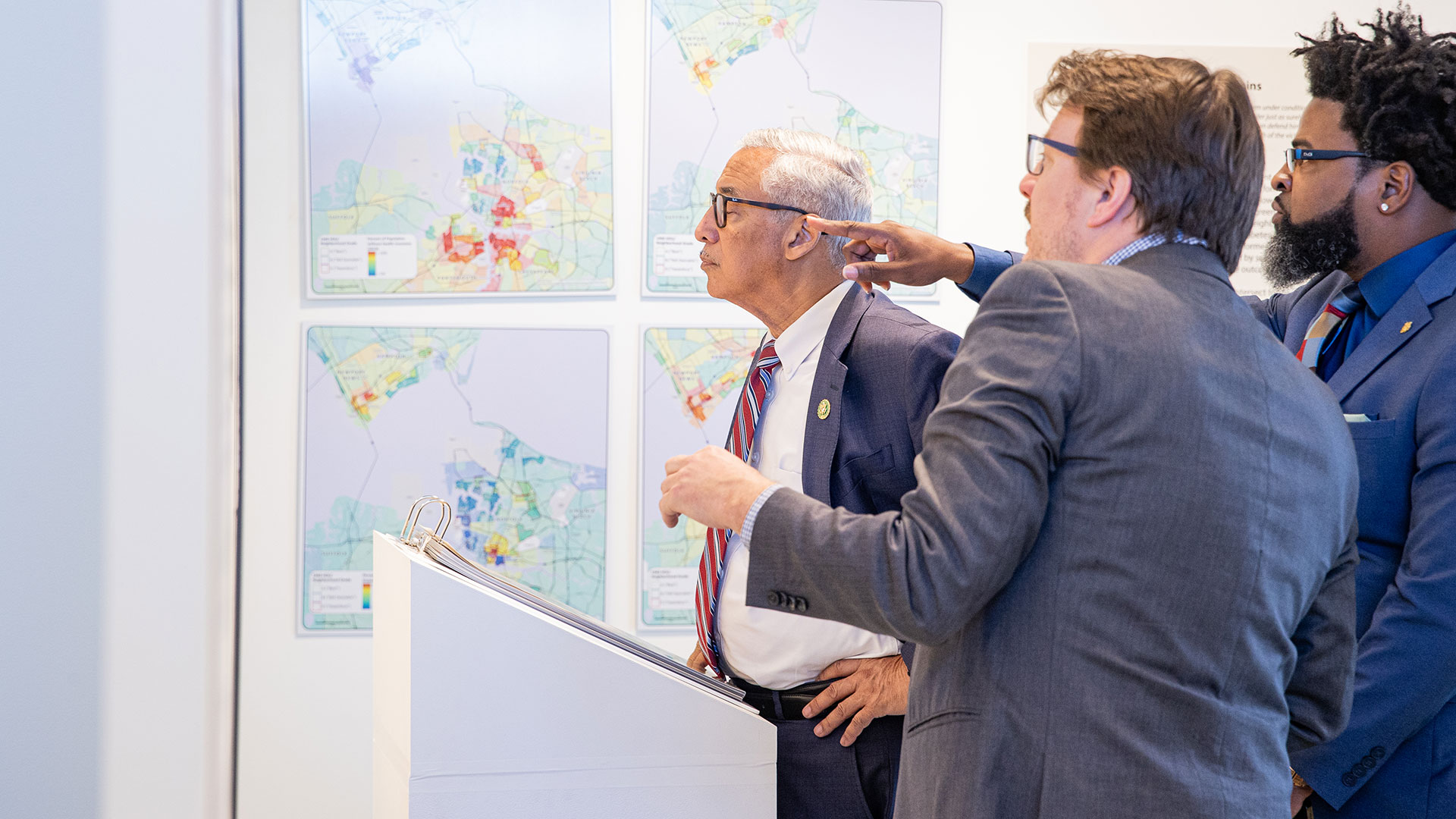 Professor presenting an mapping exhibit demonstrating the inequality of housing practices