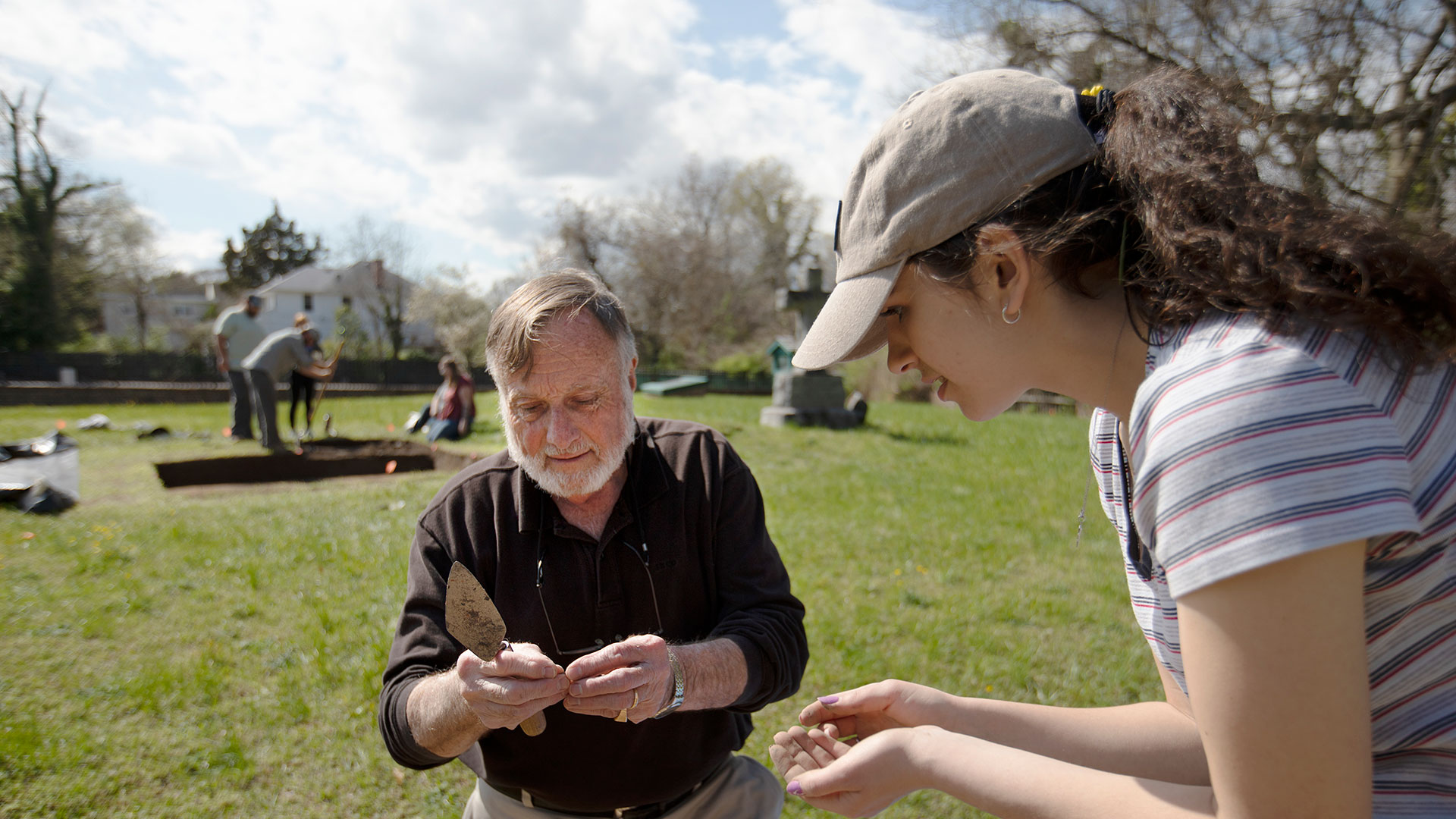 Student and professor at an archaeological dig