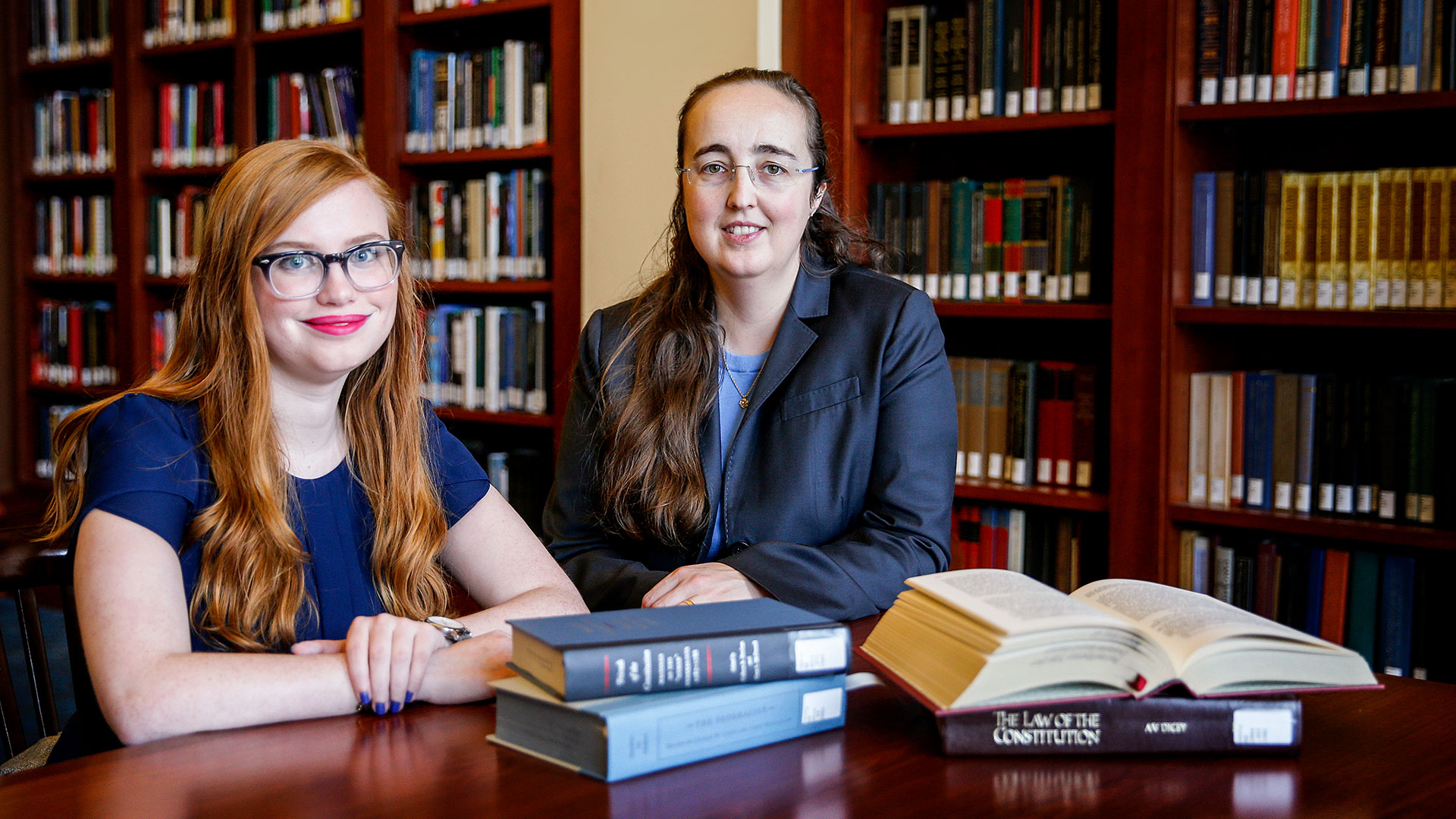 Student and professor with law books