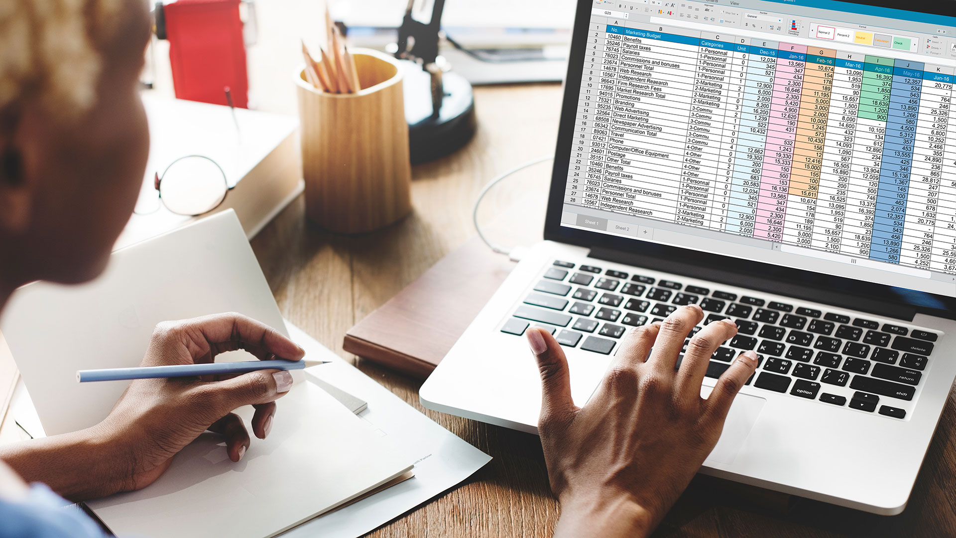 Woman working on a laptop creating an expense report