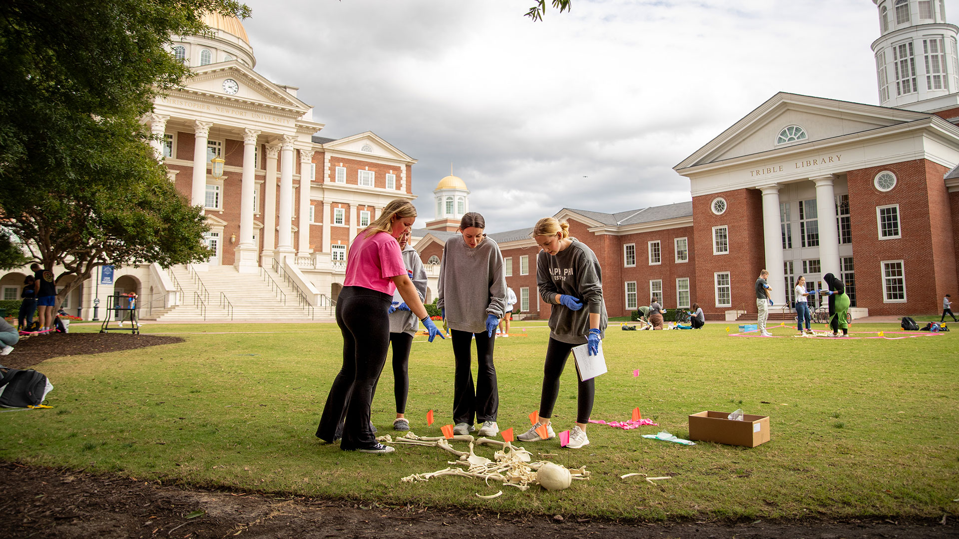 Students examine bones on the Great Lawn as part of a forensic science class